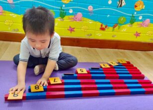 Young child engaging with colorful educational toys on the floor