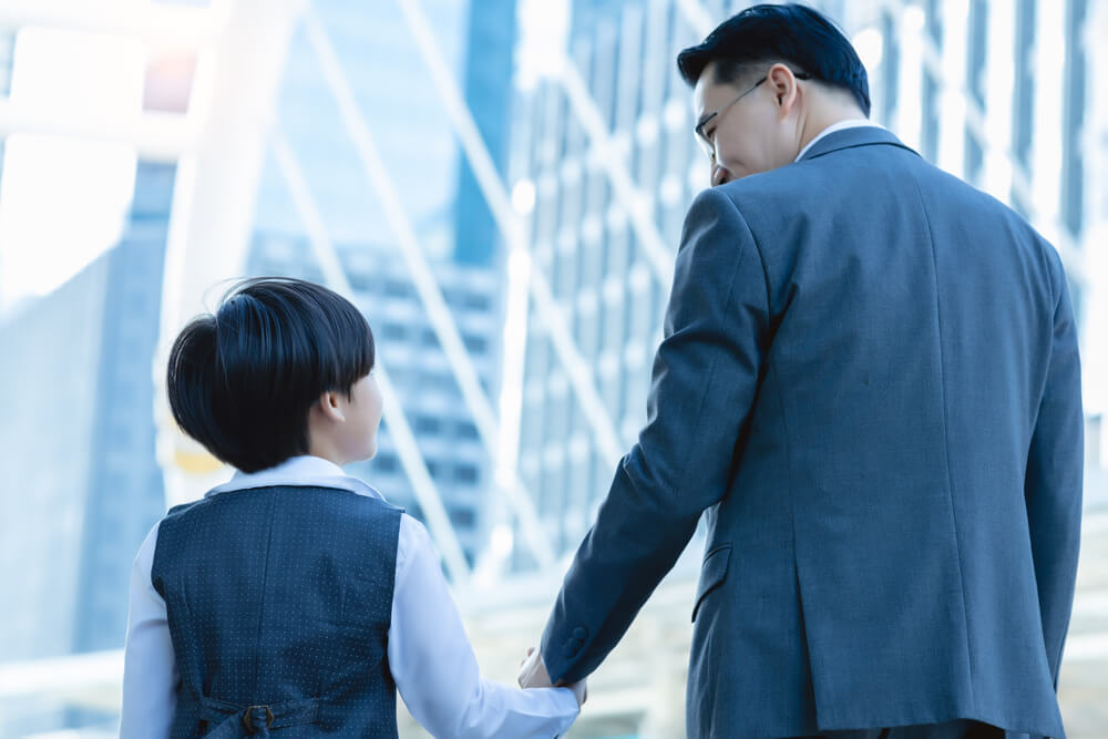 Professional and child in business attire walking together