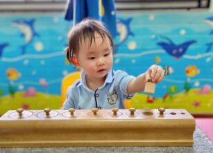 Toddler playing with a wooden toy to enhance cognitive skills