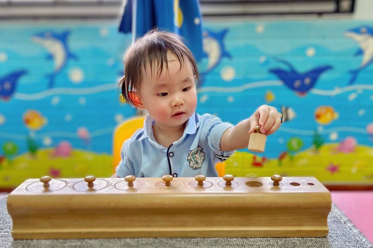 Toddler playing with a wooden toy to enhance cognitive skills