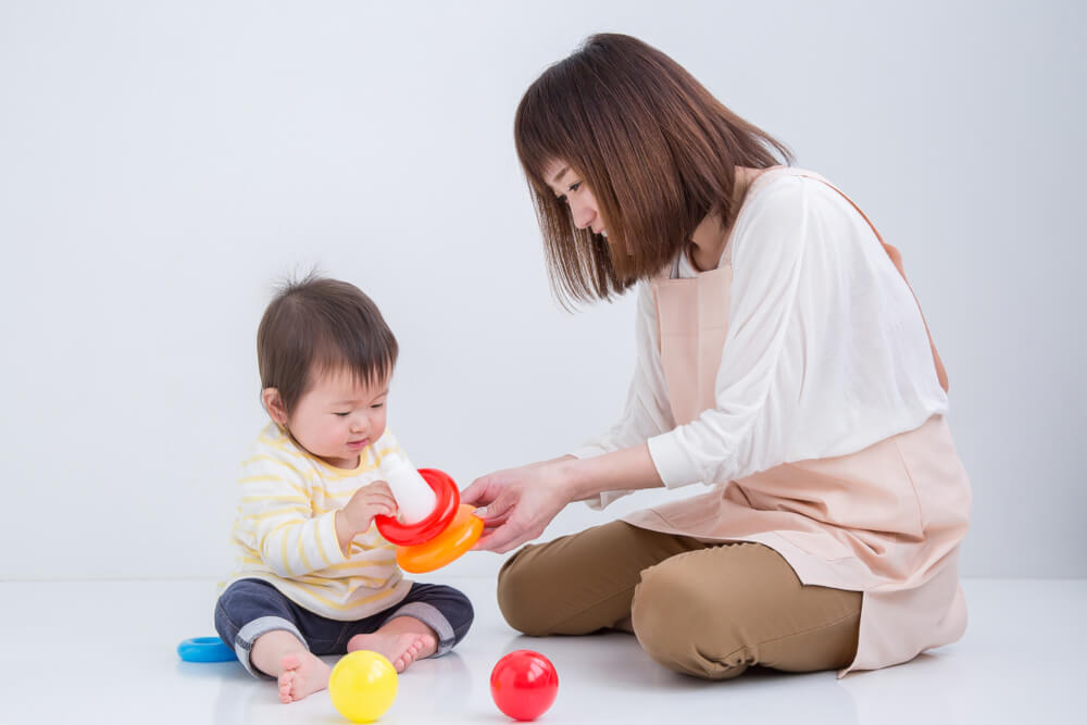 Teacher playing with infant