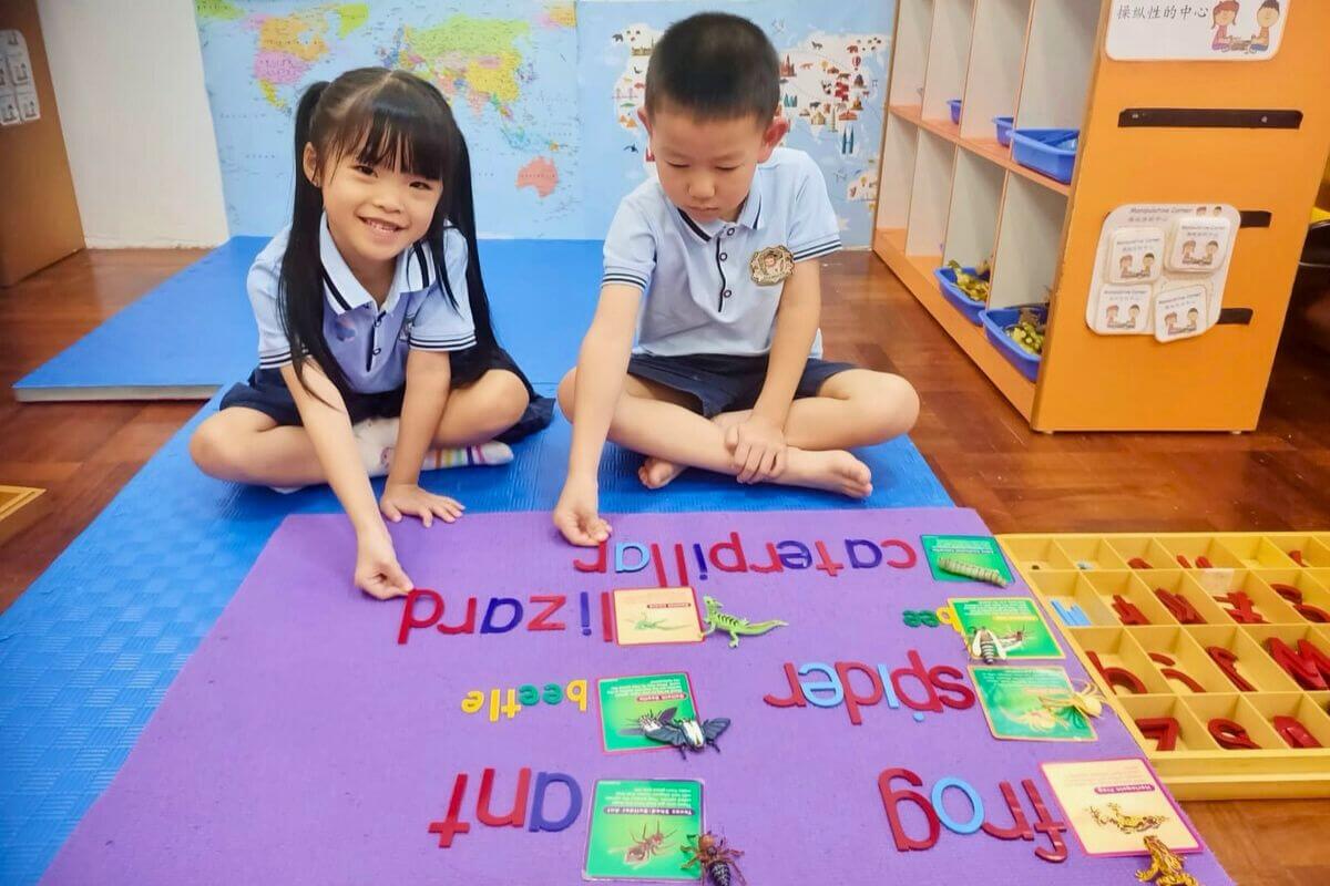 Children engaged in a preschool activity learning animal names and letters, developing early literacy and vocabulary through fun educational play at Starshine Montessori.