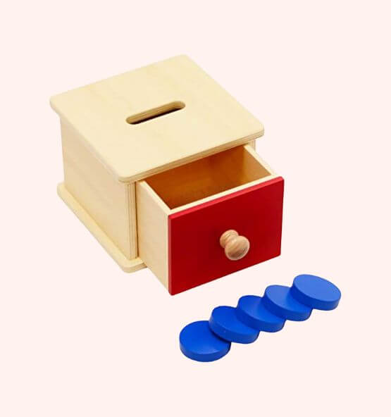 Montessori coin box with thick blue coins, wooden toy designed for developing hand-eye coordination, fine motor skills, and early learning in children.