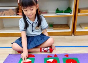 A young girl engaging with Montessori fraction circles, demonstrating fractions visually, in a well-organised Montessori classroom at Starshine Montessori.