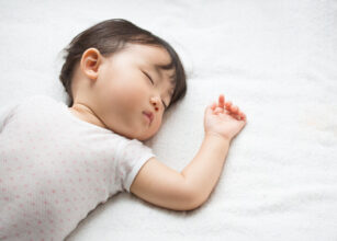 Peaceful baby sleeping soundly, capturing a calm nap time moment for infant rest and growth.