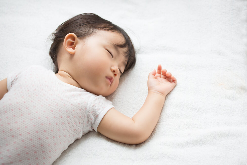 Peaceful baby sleeping soundly, capturing a calm nap time moment for infant rest and growth.