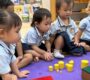 Children Exploring Yellow Cylinders Starshine Montessori 90x80