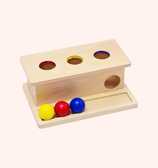 Montessori Object Permanence Box with colored balls – A wooden Montessori toy designed for early childhood development, helping toddlers enhance hand-eye coordination, fine motor skills, and color recognition through engaging play.